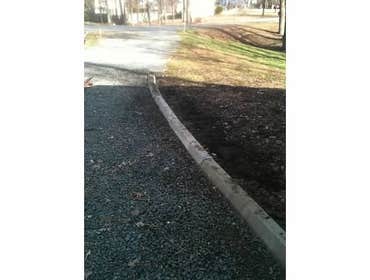Driveway This driveway was widened and made more functional with a retaining wall and concrete pavers.