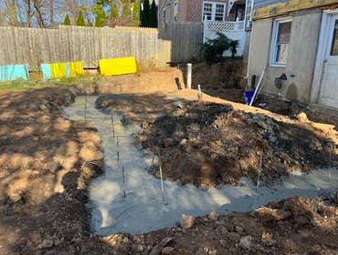 New Street Walls and Garage Floor For this project we followed the plans to install concrete footers, foundation walls and garage floor for a future 3 