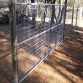 Fence Enclosure for Rescued Cats 850' of 6' high 2" x 4" fence with 5 gates. Project includes underground gopher wire along fence line to prevent coyo