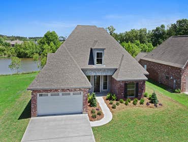 Photo(s) from Jenkins Homes, Inc. This custom home in Madisonville, LA is a 3 bedroom, 2 full/2 half bath home nicely situated on a beautiful pond. The