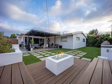 backyard remodeling costa mesa custom aluminum patio cover, concrete patio deck, artificial turf with stepping stones, custom BBQ, sitting area with cu
