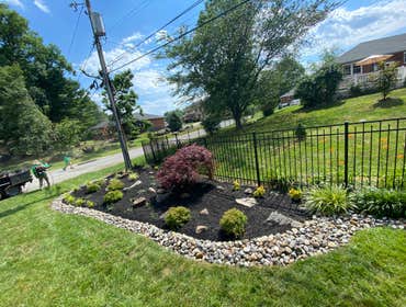 Photos by Madlandscape #1 Bear dirt turned into a nice mulch bed with rocks, all around and some flowers to give it some color beautiful bed with trees