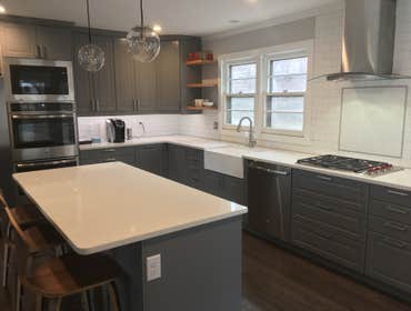 IKEA Bodbyn gray cabinetry with quartz countertops and matte finish subway tile