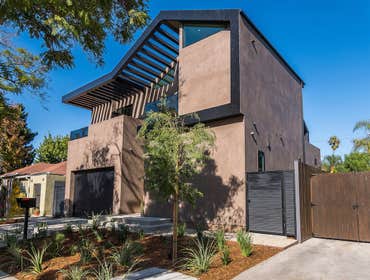 Spacious Entertainment New Home Remodel Warm tones create coziness in this modern home. A 25ft pocket door merges indoor/outdoor spaces, ensuring a har