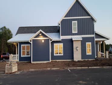 New Home CertainTeed Landmark pewter colored Shingles.
McElroy 16inch White 26ga snap lock standing seam.