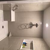 Photos by Battles Home Improvement Co Inc #1 Custom walk in shower complete with bench seat, recessed shampoo shelf, foot rest, safety bars and a hand