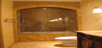 Photo(s) from Wagner Tile & Plumbing Granite Shower, Arched Valance, Marble Pinwheel Floor