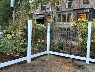 Photos by Strong Innovative Structures Inc #5 Backyard renovation including installation of large-format pavers and a white vinyl privacy fence, creati