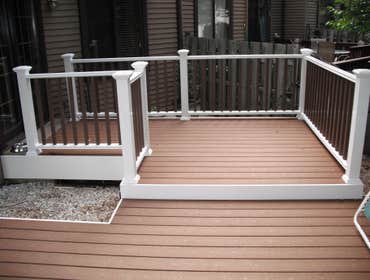 composite decking Customer had a brick patio that was on an uneven grade. We built a new composite deck with a vinyl railing system. Now they can have 