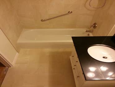 Full bathroom remodel 12x24 porcelain on walls and floor. Tile baseboards.